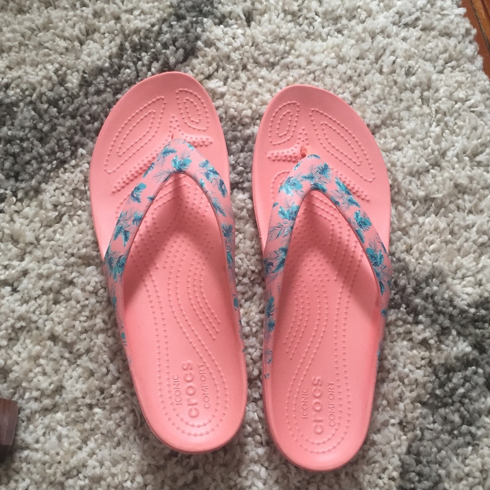 Pink Croc flip flops with palm tree design